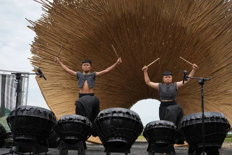 竹構藝術作品《穿越》29日在屏東林後四林平地森林園區正式啟用,以排灣族人為主體的打擊樂團「羽.擊舞藝術」應邀帶來精彩演出。中央社