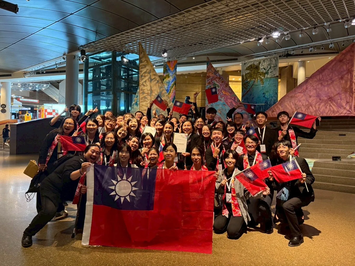 沂風室內合唱團參加新加坡國際合唱節榮獲雙獎殊榮,開心在場內揮舞國旗。