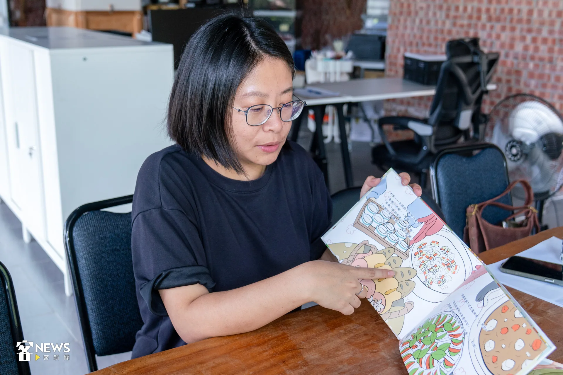 顏惟親翻開繪本第一頁，她向我們介紹眼前這頭「青獅大人」。洪藝晅攝