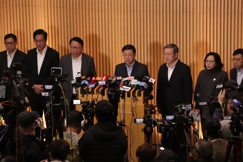 香港行政長官李家超(後排中間)27日率同主要官員說明大埔宏福苑大火。中央社