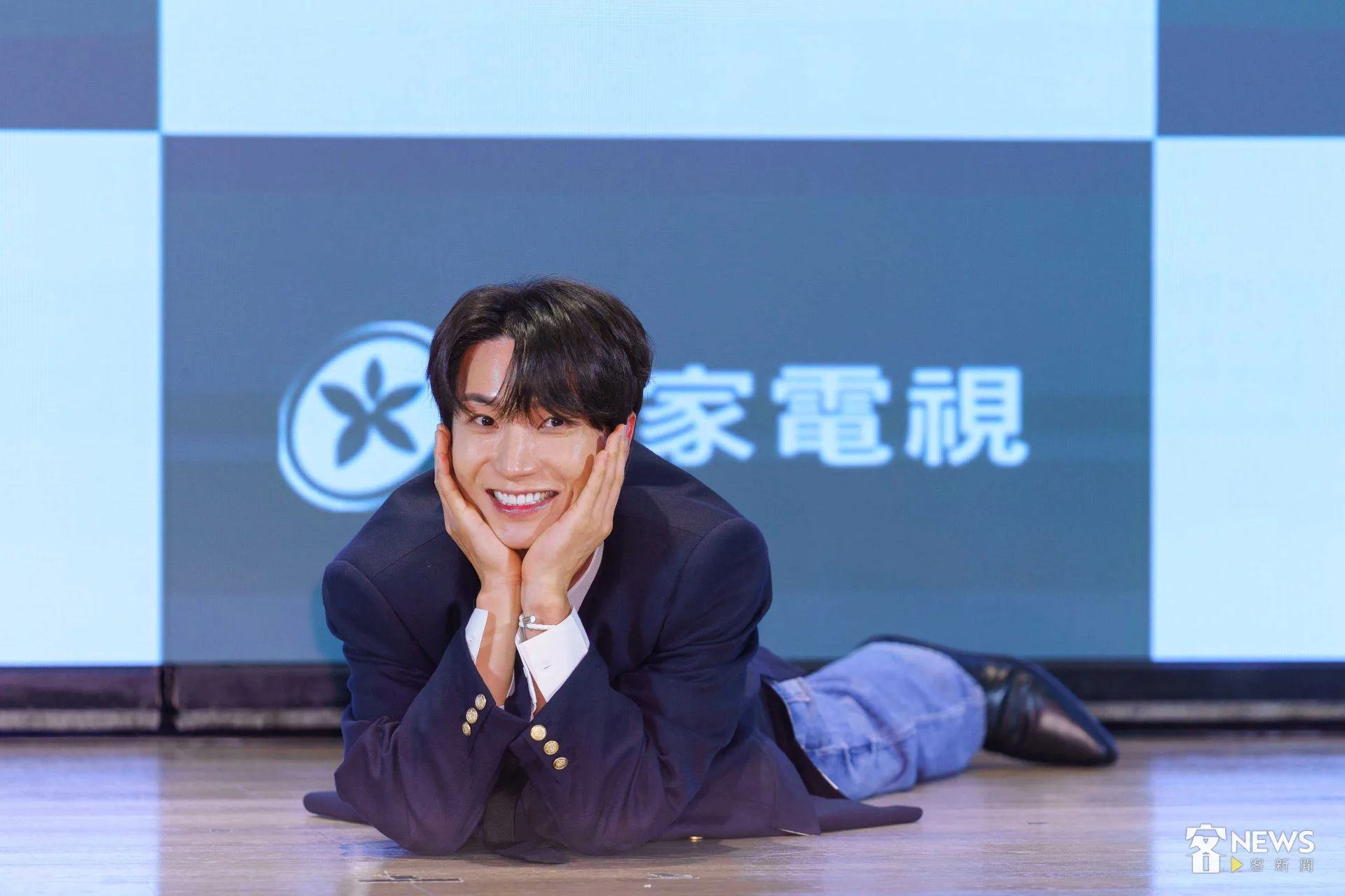 貼心的利特趴在《客家電視》的LOGO旁拍照,宣傳《客家廚房2》播出平台。李台源攝