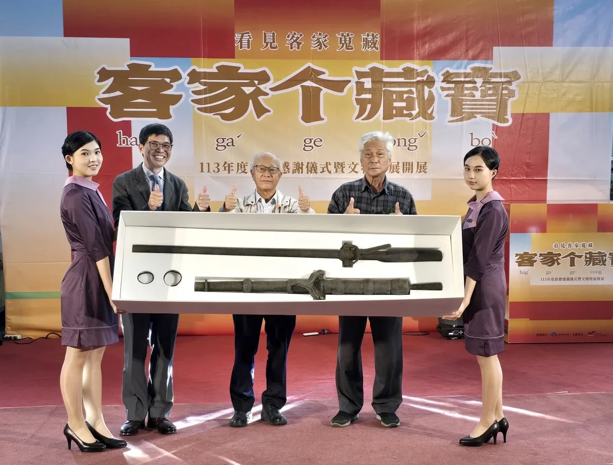 客發中心主任何金樑（左2）回贈佳冬蕭屋古炮予蕭家祖屋管理委員會前主委蕭義雄（右2）。客發中心提供