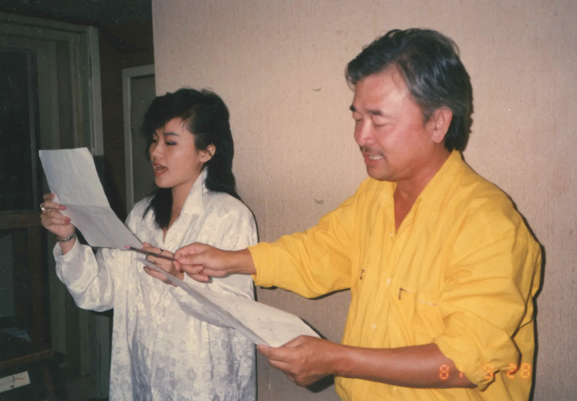 1983年出版〈捱係中國人〉之後，涂敏恆（右）花了四年時間終於找到華視基本歌星的魏海姍（左）來唱他新創作的客家歌，這是他們於1987年在錄音室練唱的情形。張致遠攝