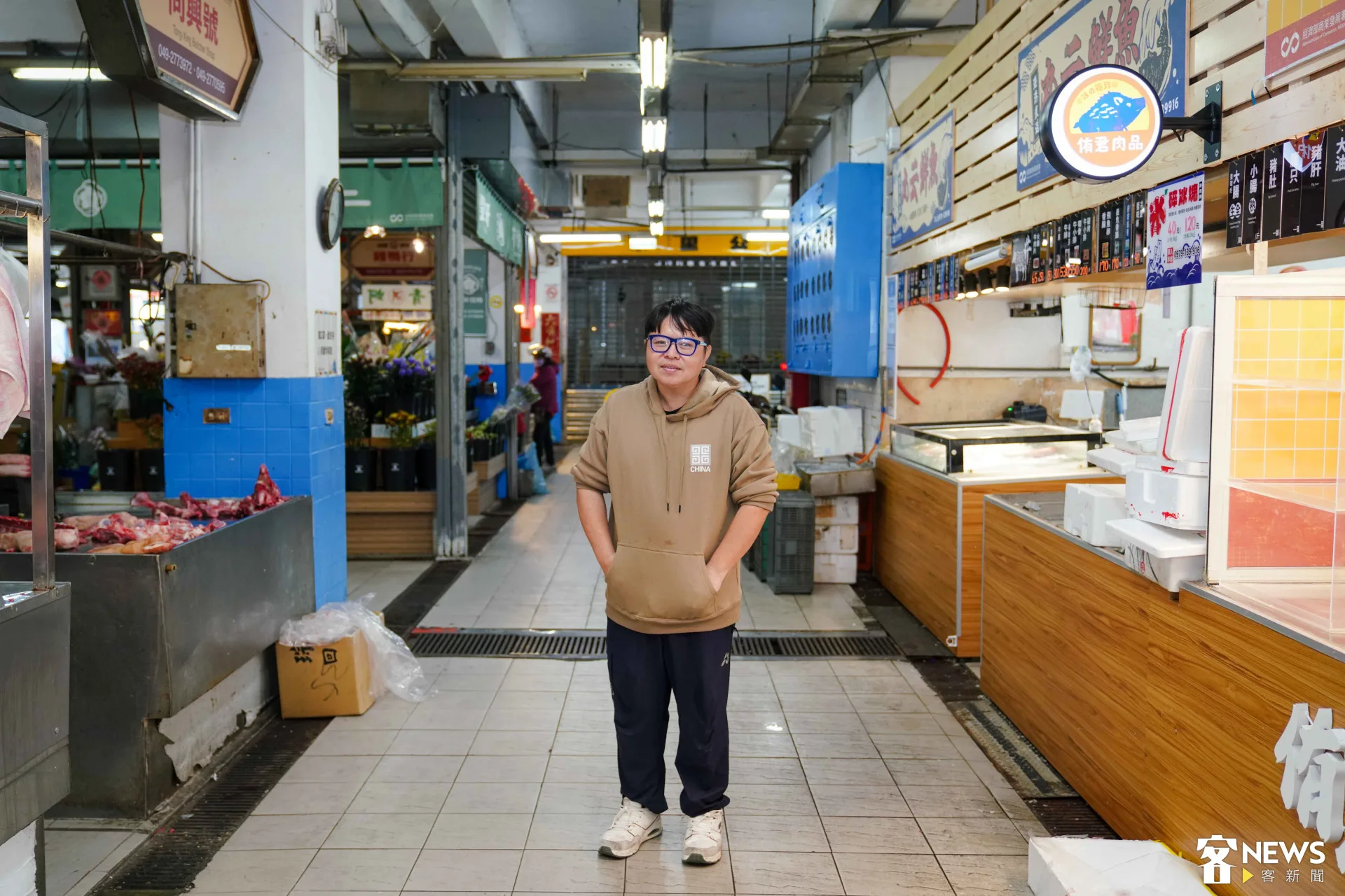 董于安領著《客新聞》記者逐層參觀水里市場,細數每個角落和攤位發生的事。朱愷元攝