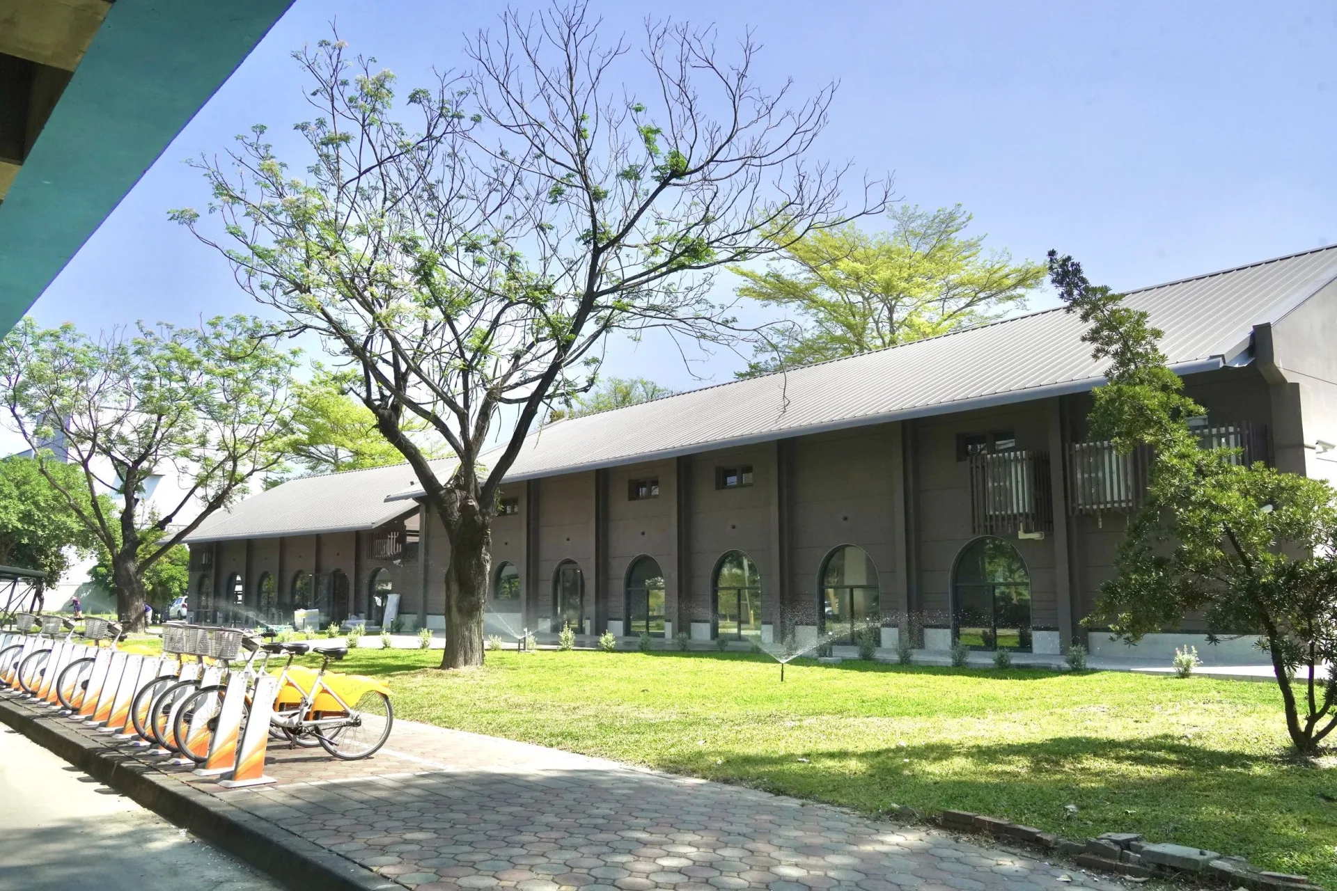 屏東縣政府以「好客・舒活・慢慢走」為核心理念,活化台鐵舊有一號倉庫(右)、二號倉庫(左),融合客家元素、日式生活美學與在地特色餐飲,打造具有展演、餐飲與背包客旅宿等多功能場域。屏東縣政府提供