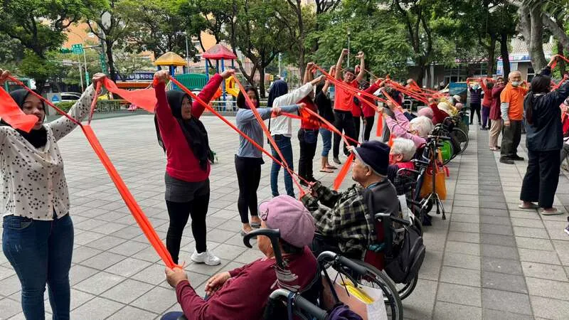 外界擔憂鬆綁外傭申請條件，恐衝擊家事服務人員就業。圖為外籍看護陪伴長輩運動。弘道老人福利基金會提供
